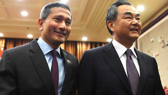 Singapore's Foreign Minister Vivian Balakrishnan (L) walks with Chinese Foreign Minister Wang Yi before a meeting at the Ministry of Foreign Affairs in Beijing, China on June 12, 2017.