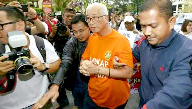 Penang executive councillor Phee Boon Poh being led by MACC officers to the Magistrate's Court for his remand application today.