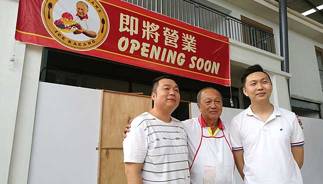 Fourth-generation ais kacang seller Lee Eng Lai, 67, pointing to his shop's signage at the New World Park food mall in Burma Road, George Town, Penang.