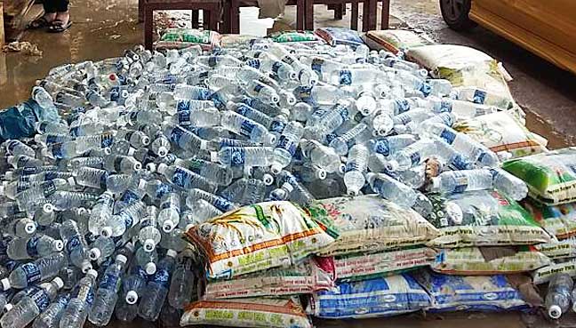 Hundreds of bottles of drinking water and sacks of rice damaged by flood in Kinarut town.
