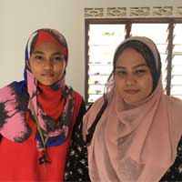 Leniyusnita Amrizal (right) with her sister. Their house is 500 metres away from the highwayconstruction area.