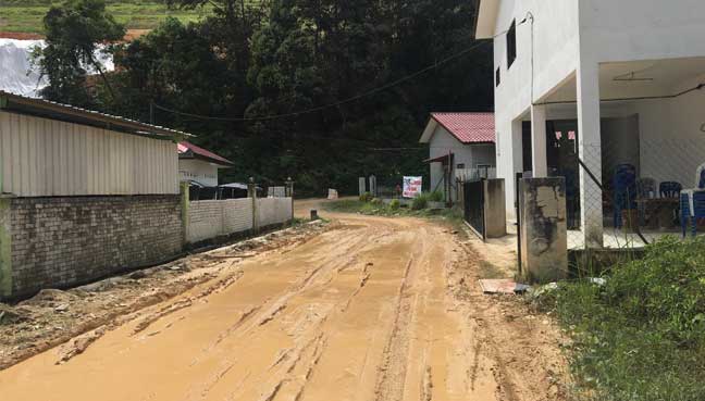 The muddy road in front of the tahfiz school.