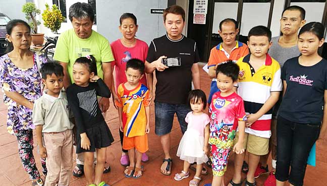 Loh Wei Hun (back row, fourth from left) with parents and seven stateless children who were asked to show passports to enrol in school.