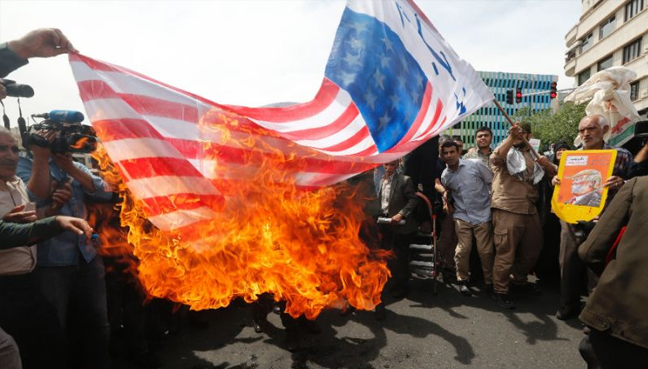 Iranians set fire to a US flag during a demonstration in Tehran