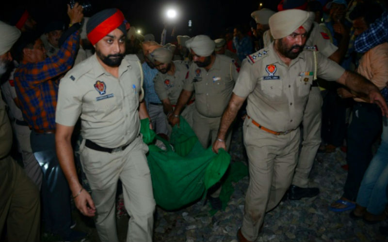 At least 60 people dead after train ploughs through crowd in India At least 60 people dead after train ploughs through crowd in India