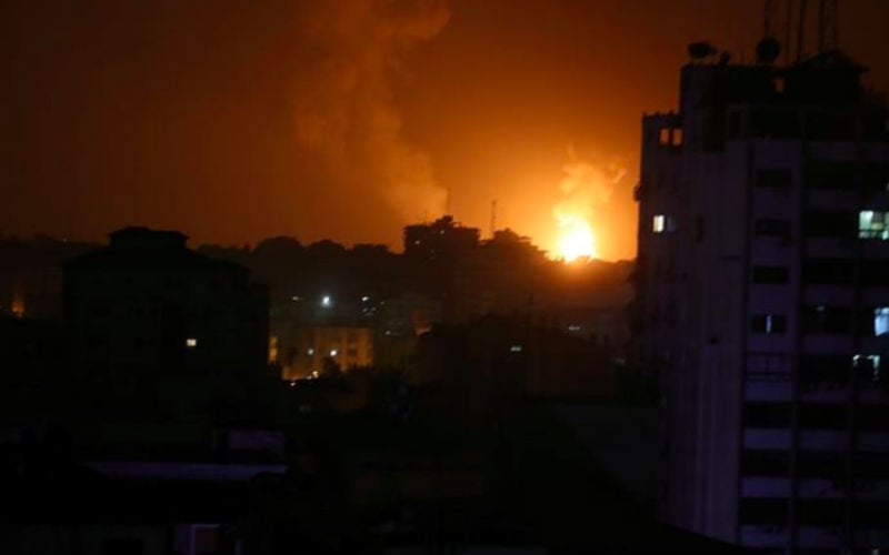Smoke and flames are seen during an Israeli air attack on Gaza on Friday
