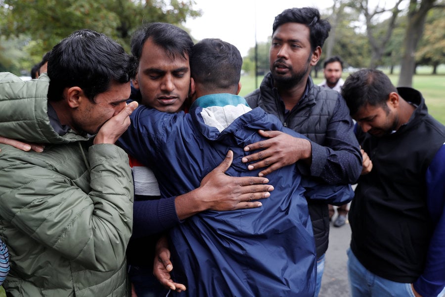 Relatives of a victim of the mosque shootings wait for news at a community centre in Christchurch New Zealand