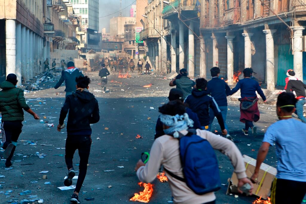 Demonstrators and security forces lob Molotov cocktails at each other during clashes