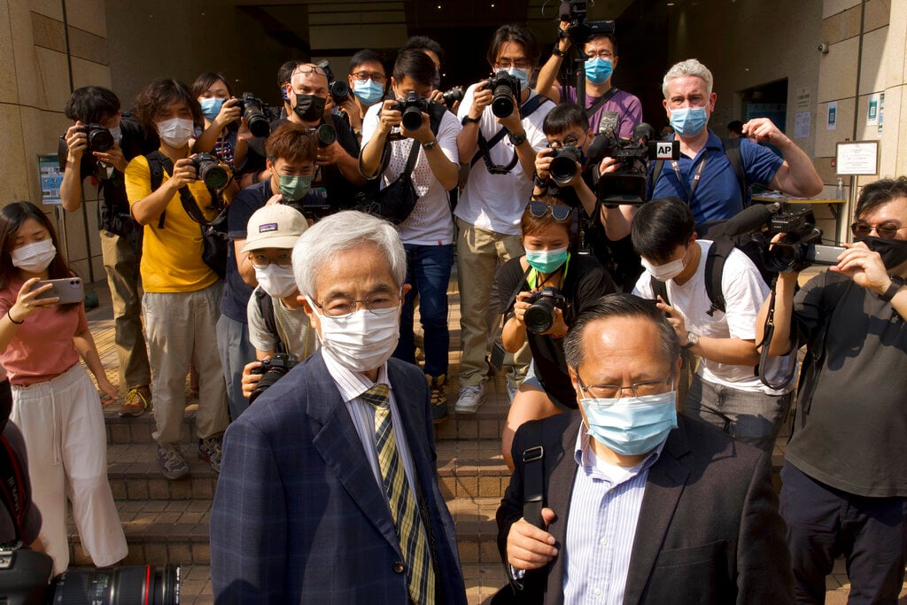 Pro-democracy lawmaker Martin Lee and Albert Ho arrive at a court in Hong Kong today
