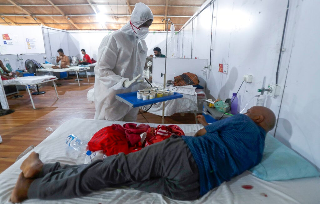 A health worker offers tea to a patient at a field hospital one of the largest Covid-19 facilities in Mumbai on Friday