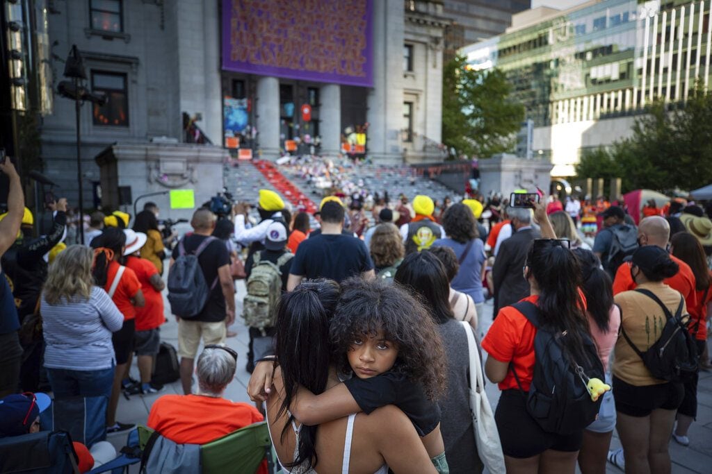 People at a ceremony and a vigil yesterday for the 215 children whose remains were found in Vancouver